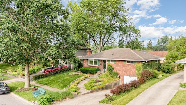4453 Marland Dr, Columbus, OH 43224 - view of front facade with brick siding, a front yard, and roof with shingles