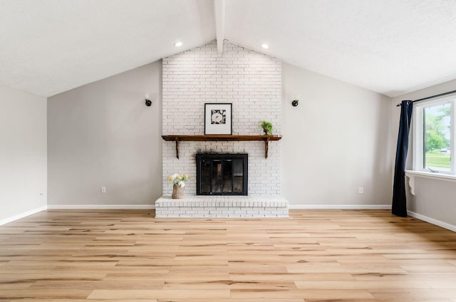 3623 Bolamo Dr, Westerville, OH 43081 - unfurnished living room featuring wood finished floors, lofted ceiling, a fireplace, and a textured ceiling