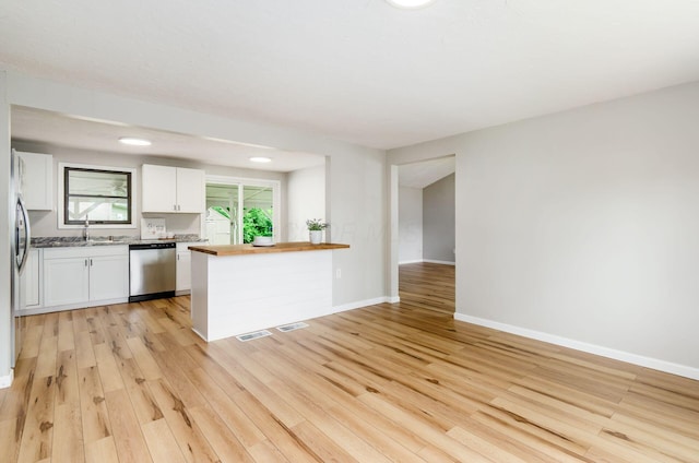 3623 Bolamo Dr, Westerville, OH 43081 - kitchen featuring stainless steel dishwasher, white cabinetry, light wood-style floors, butcher block counters, and a peninsula