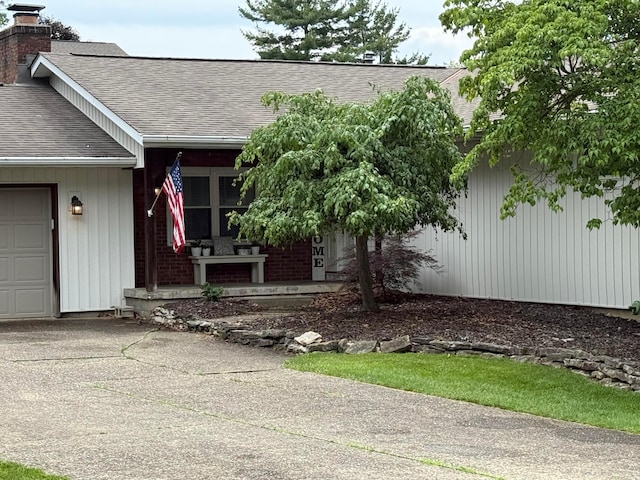 1819 Walnut Rd, Heath, OH 43056 - property entrance featuring a shingled roof, a chimney, and a porch