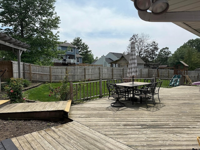 1819 Walnut Rd, Heath, OH 43056 - deck featuring outdoor dining space, a fenced backyard, and a playground