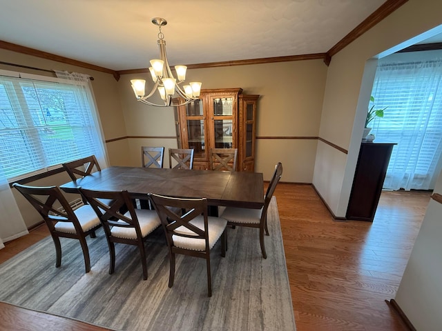 1819 Walnut Rd, Heath, OH 43056 - dining room with wood finished floors, a chandelier, and crown molding