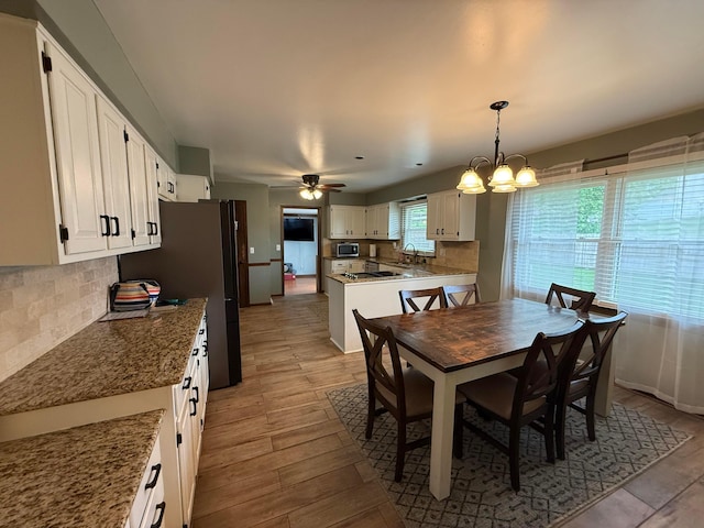 1819 Walnut Rd, Heath, OH 43056 - dining room with light wood-type flooring, a ceiling fan, and a chandelier