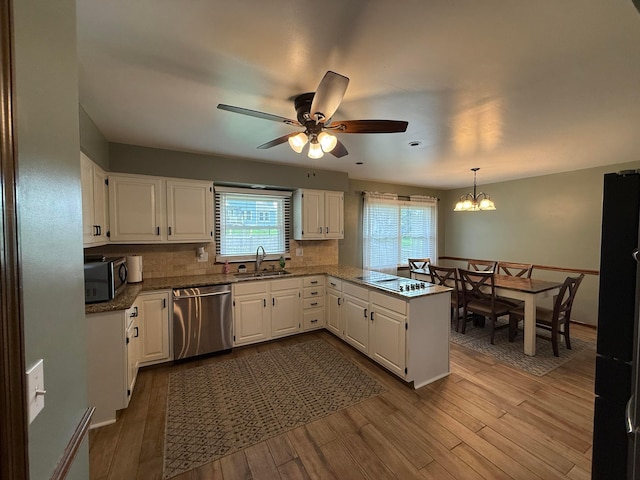 1819 Walnut Rd, Heath, OH 43056 - kitchen with stainless steel appliances, a peninsula, white cabinetry, and a ceiling fan