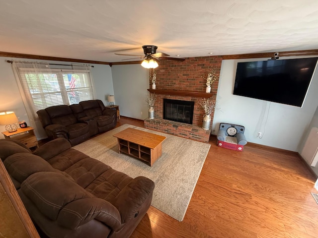 1819 Walnut Rd, Heath, OH 43056 - living room featuring ceiling fan, wood finished floors, a brick fireplace, and crown molding