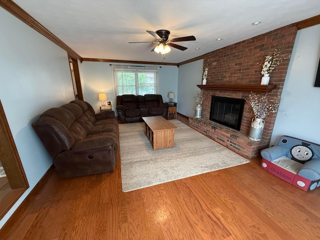 1819 Walnut Rd, Heath, OH 43056 - living room with a ceiling fan, wood finished floors, ornamental molding, and a brick fireplace