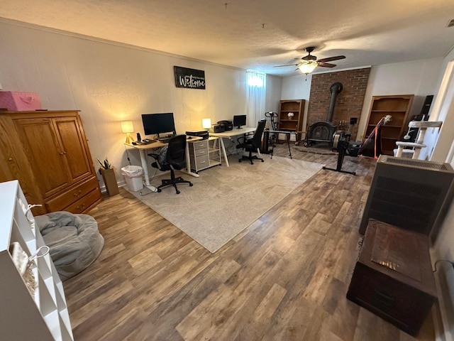 1819 Walnut Rd, Heath, OH 43056 - office space featuring wood finished floors, a wood stove, ceiling fan, and a textured ceiling