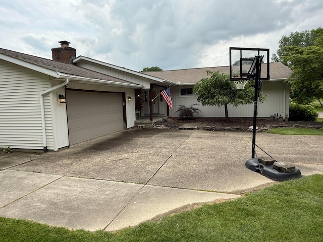 1819 Walnut Rd, Heath, OH 43056 - view of front of home with a chimney, a shingled roof, a garage, and concrete driveway