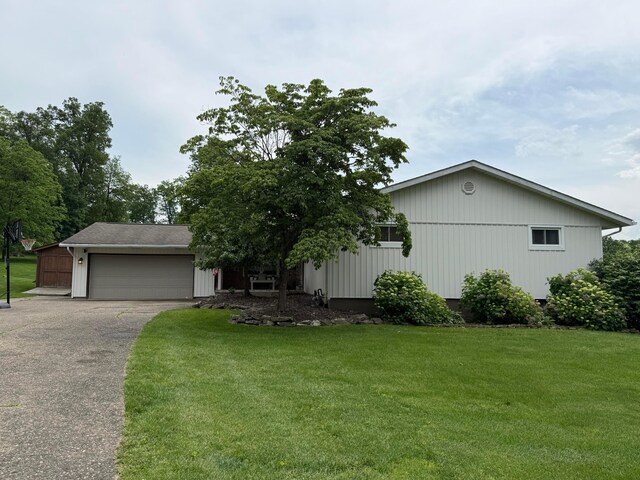 1819 Walnut Rd, Heath, OH 43056 - view of front of property with asphalt driveway, a garage, and a front lawn