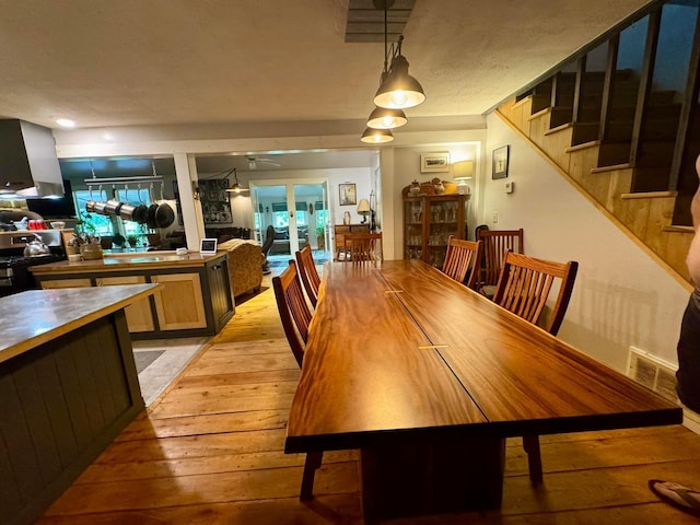 6598 Jeff Ln, Athens, OH 45701 - dining area with light wood-type flooring, stairway, and a ceiling fan