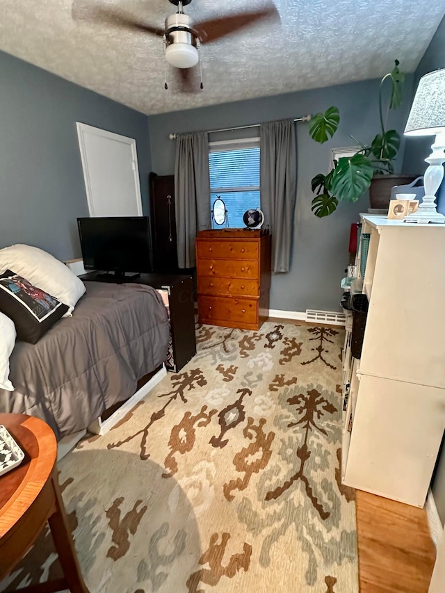 6869 Cedar Brook Pl, New Albany, OH 43054 - bedroom featuring a textured ceiling and a ceiling fan