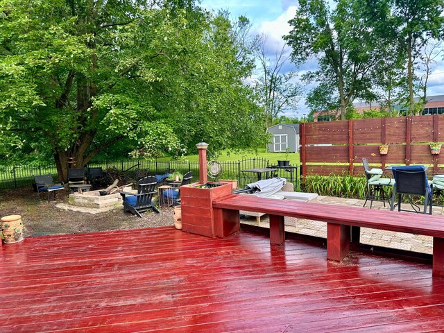 6869 Cedar Brook Pl, New Albany, OH 43054 - wooden terrace featuring outdoor dining area, a shed, and a fenced backyard