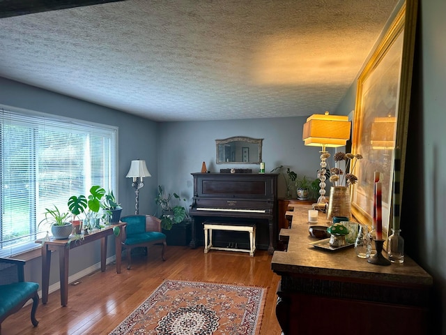 6869 Cedar Brook Pl, New Albany, OH 43054 - sitting room with wood finished floors and a textured ceiling