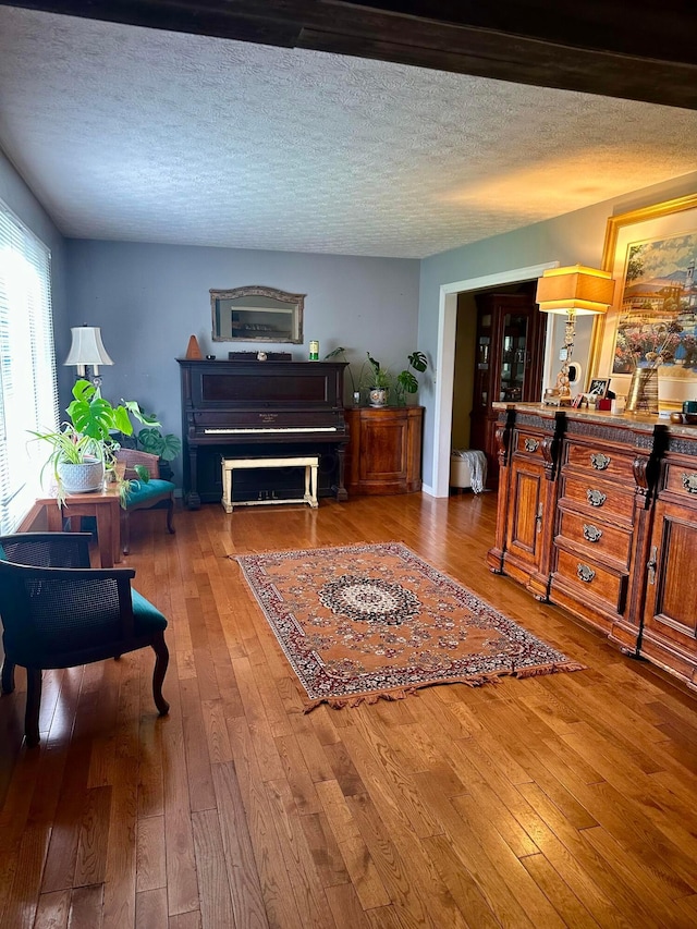 6869 Cedar Brook Pl, New Albany, OH 43054 - living area featuring hardwood / wood-style floors and a textured ceiling