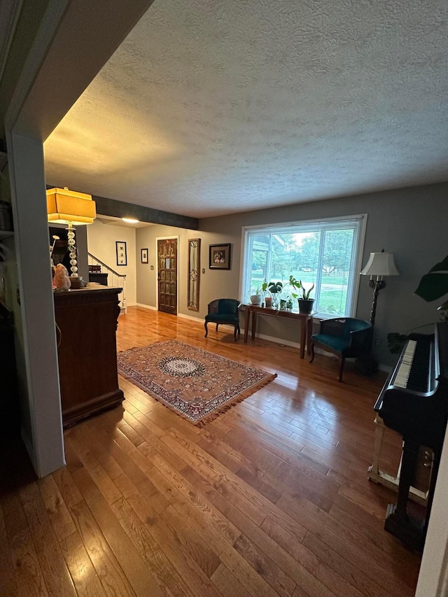 6869 Cedar Brook Pl, New Albany, OH 43054 - living room with a textured ceiling and hardwood / wood-style flooring