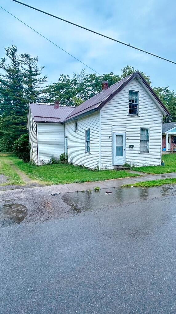 409 Lawrence St, Bellefontaine, OH 43311 - view of front of house with a chimney and a metal roof
