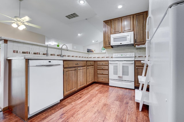 151 Cameron Ridge Dr, Columbus, OH 43235 - kitchen featuring white appliances, light wood finished floors, light countertops, decorative backsplash, and ceiling fan