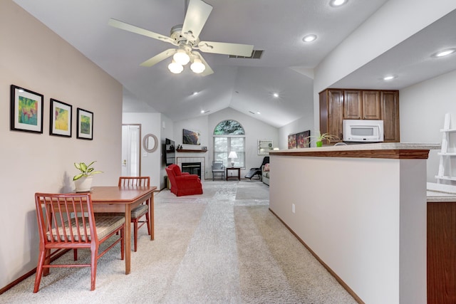 151 Cameron Ridge Dr, Columbus, OH 43235 - dining space featuring a tile fireplace, ceiling fan, light colored carpet, lofted ceiling, and recessed lighting