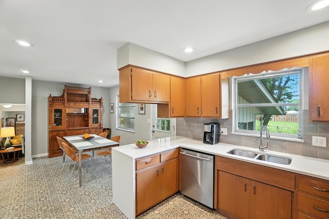5445 Rockwood Rd, Columbus, OH 43229 - kitchen with stainless steel dishwasher, light countertops, backsplash, a peninsula, and recessed lighting