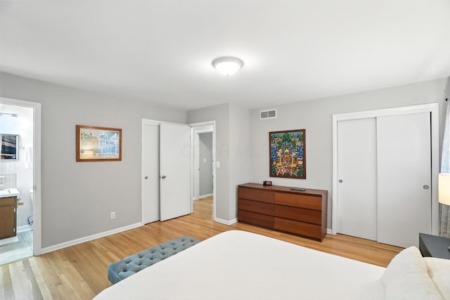 5445 Rockwood Rd, Columbus, OH 43229 - bedroom with light wood-style floors, ensuite bathroom, and multiple closets
