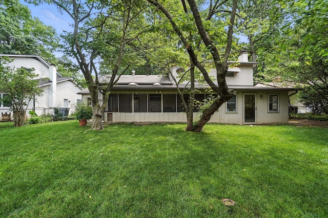 5445 Rockwood Rd, Columbus, OH 43229 - back of house featuring a sunroom and a chimney