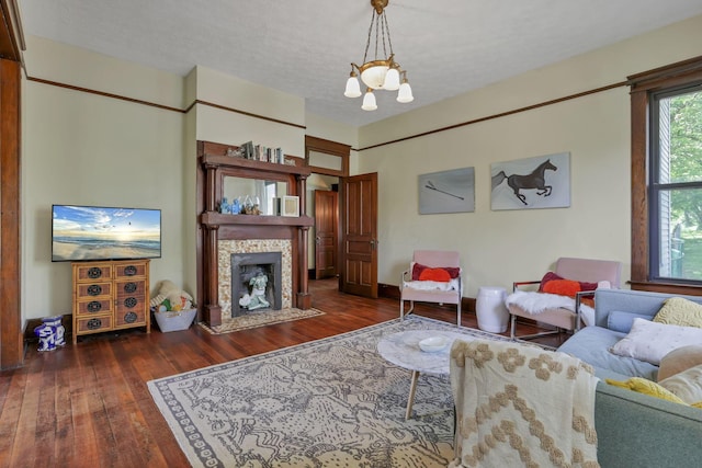 300 E Main St, Somerset, OH 43783 - living area with wood-type flooring, a tile fireplace, and a chandelier