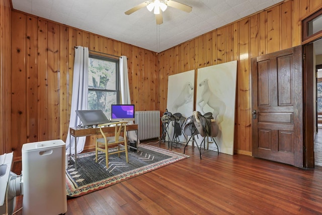300 E Main St, Somerset, OH 43783 - office area featuring radiator, ceiling fan, wood finished floors, and wood walls
