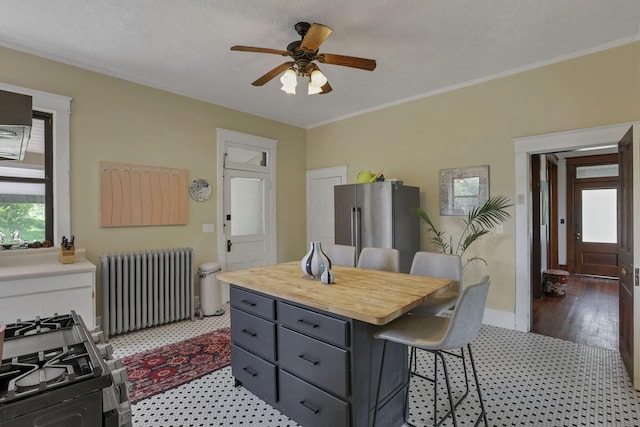 300 E Main St, Somerset, OH 43783 - kitchen featuring radiator, freestanding refrigerator, a breakfast bar area, healthy amount of natural light, and ornamental molding