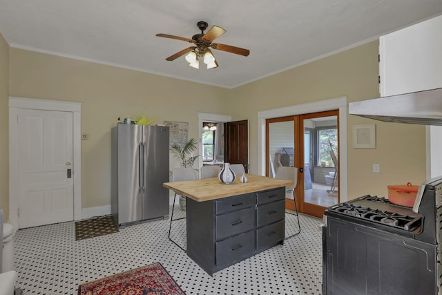 300 E Main St, Somerset, OH 43783 - kitchen with high quality fridge, gas stove, wood counters, healthy amount of natural light, and ornamental molding