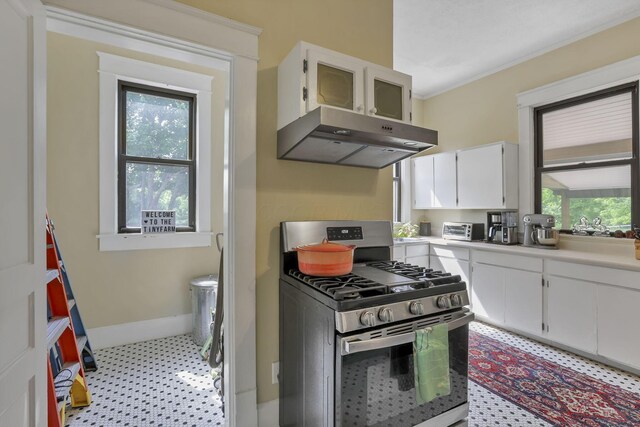 300 E Main St, Somerset, OH 43783 - kitchen featuring stainless steel gas range oven, under cabinet range hood, light flooring, white cabinetry, and light countertops