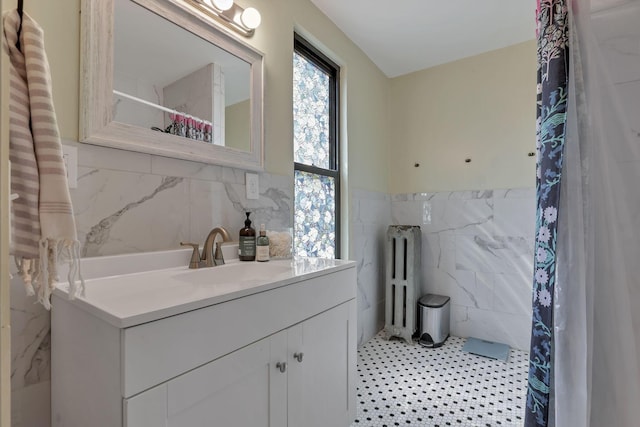 300 E Main St, Somerset, OH 43783 - bathroom with tile walls, radiator, vanity, wainscoting, and a shower with shower curtain
