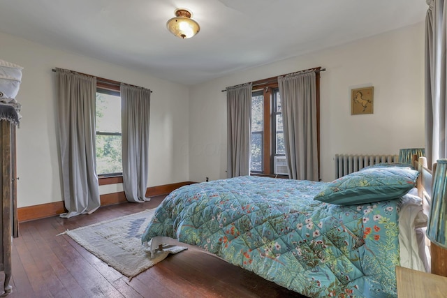 300 E Main St, Somerset, OH 43783 - bedroom featuring radiator heating unit, multiple windows, and wood-type flooring