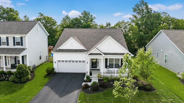 7087 Ribault Dr NW, Pickerington, OH 43147 - traditional home featuring covered porch, a front yard, a garage, asphalt driveway, and roof with shingles