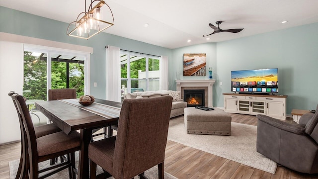 7087 Ribault Dr NW, Pickerington, OH 43147 - dining space featuring wood finished floors, a fireplace, recessed lighting, ceiling fan, and a chandelier
