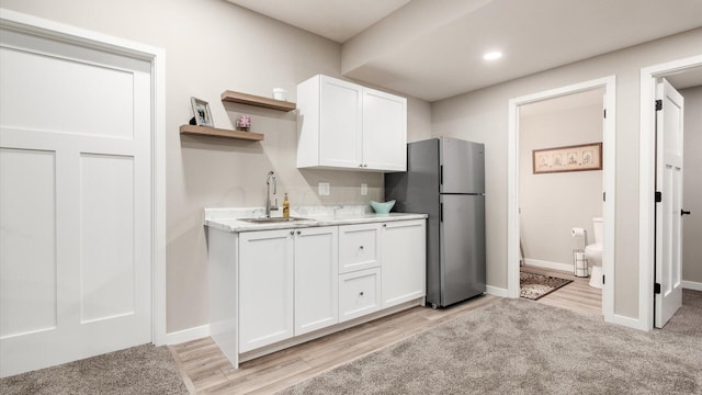 7087 Ribault Dr NW, Pickerington, OH 43147 - kitchen with open shelves, freestanding refrigerator, white cabinets, light wood finished floors, and recessed lighting