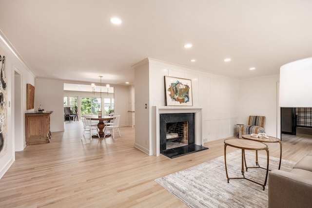 2841 Doncaster Rd, Upper Arlington, OH 43221 - living room featuring ornamental molding, recessed lighting, light wood-style flooring, and a fireplace