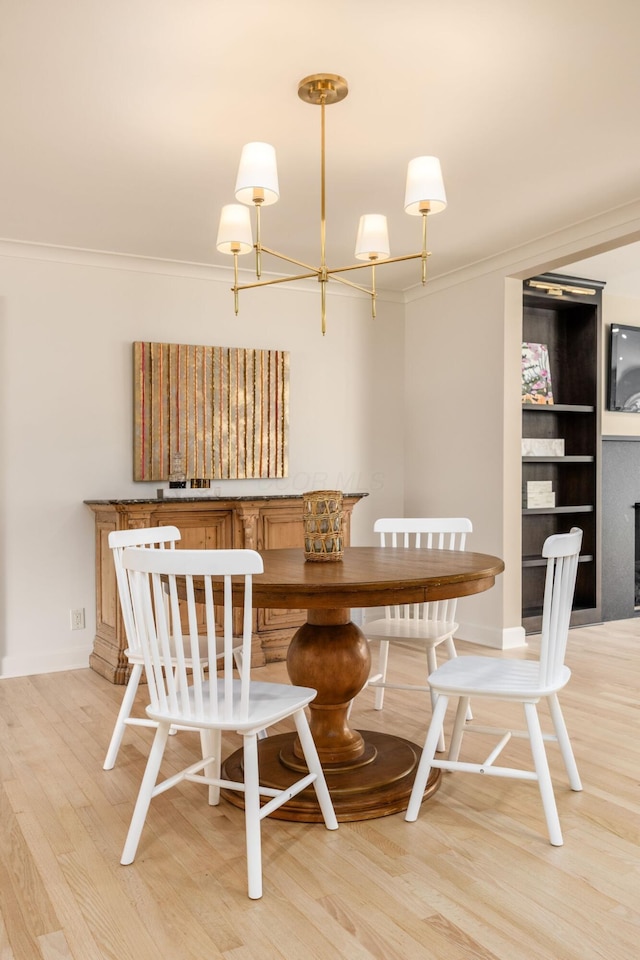 2841 Doncaster Rd, Upper Arlington, OH 43221 - dining space with ornamental molding, light wood-style flooring, and a chandelier