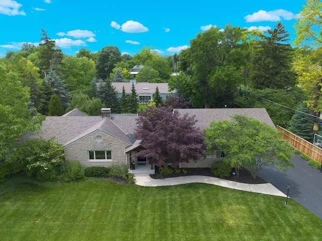 2841 Doncaster Rd, Upper Arlington, OH 43221 - view of front of property with a front lawn, stone siding, roof with shingles, and a chimney