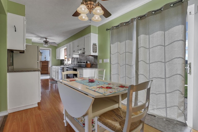 6605 Lancaster Rd SE, Hebron, OH 43025 - dining space with a ceiling fan, wood finished floors, and a textured ceiling