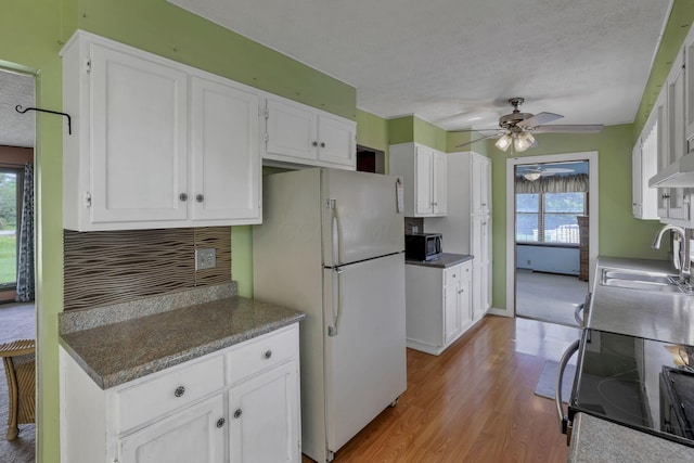 6605 Lancaster Rd SE, Hebron, OH 43025 - kitchen with freestanding refrigerator, plenty of natural light, stainless steel microwave, ceiling fan, and a textured ceiling