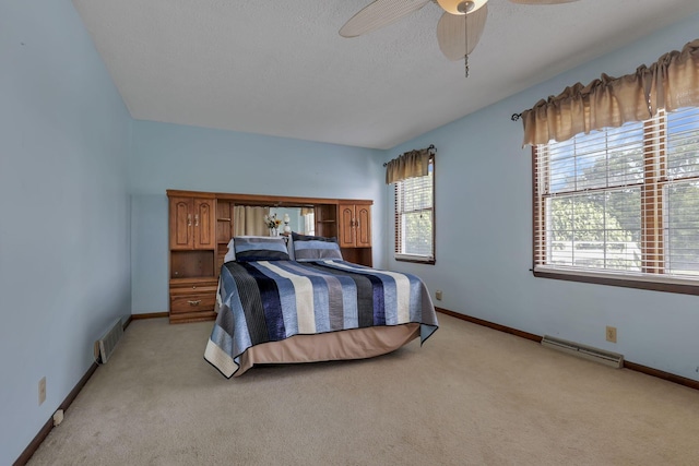 6605 Lancaster Rd SE, Hebron, OH 43025 - bedroom with light carpet, a baseboard radiator, and ceiling fan