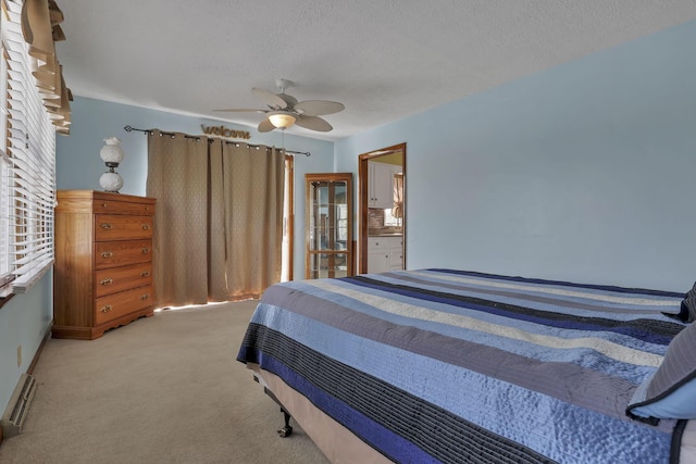 6605 Lancaster Rd SE, Hebron, OH 43025 - bedroom with light carpet, a ceiling fan, a textured ceiling, and a baseboard radiator