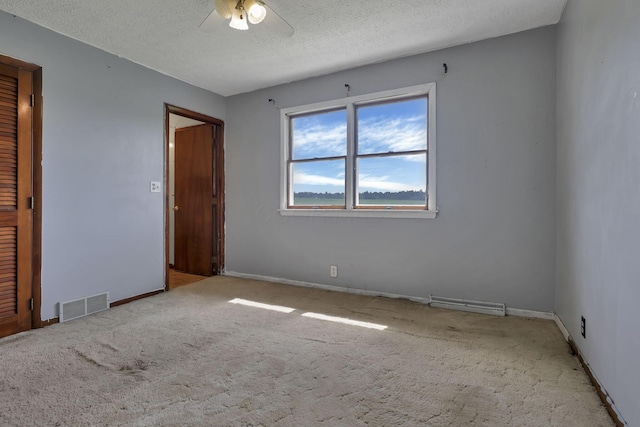 6605 Lancaster Rd SE, Hebron, OH 43025 - unfurnished bedroom featuring carpet floors, a textured ceiling, and ceiling fan