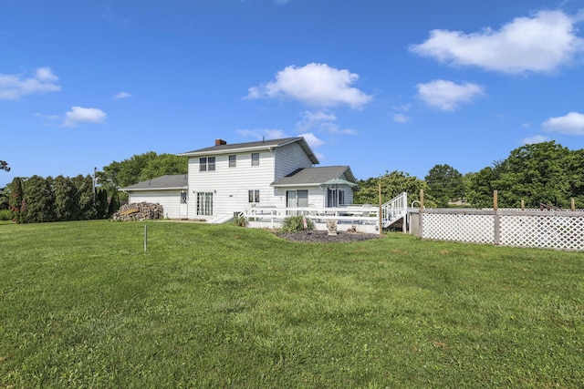 6605 Lancaster Rd SE, Hebron, OH 43025 - back of property featuring a yard, a deck, a chimney, and an attached garage