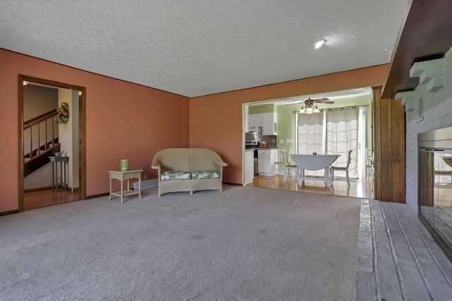 6605 Lancaster Rd SE, Hebron, OH 43025 - living area featuring a textured ceiling, stairway, and carpet