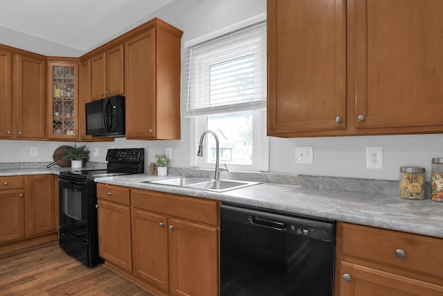 2635 Main St, Powell, OH 43065 - kitchen featuring black appliances, brown cabinetry, dark wood-type flooring, and glass insert cabinets