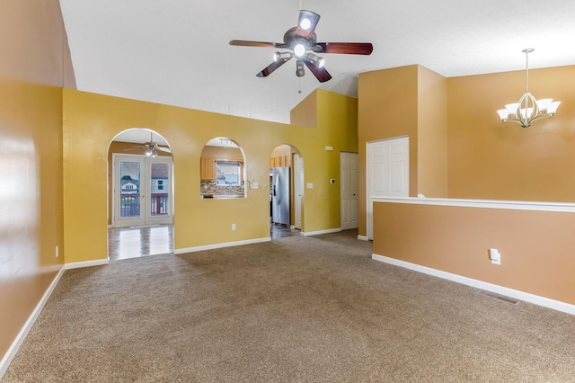 5733 Canal Bridge Dr, Canal Winchester, OH 43110 - unfurnished living room with ceiling fan, a chandelier, arched walkways, carpet flooring, and high vaulted ceiling