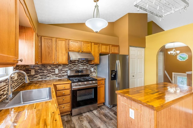 5733 Canal Bridge Dr, Canal Winchester, OH 43110 - kitchen featuring butcher block countertops, appliances with stainless steel finishes, under cabinet range hood, arched walkways, and high vaulted ceiling
