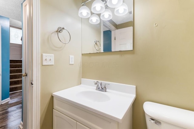 5733 Canal Bridge Dr, Canal Winchester, OH 43110 - bathroom with vanity, wood finished floors, and a chandelier