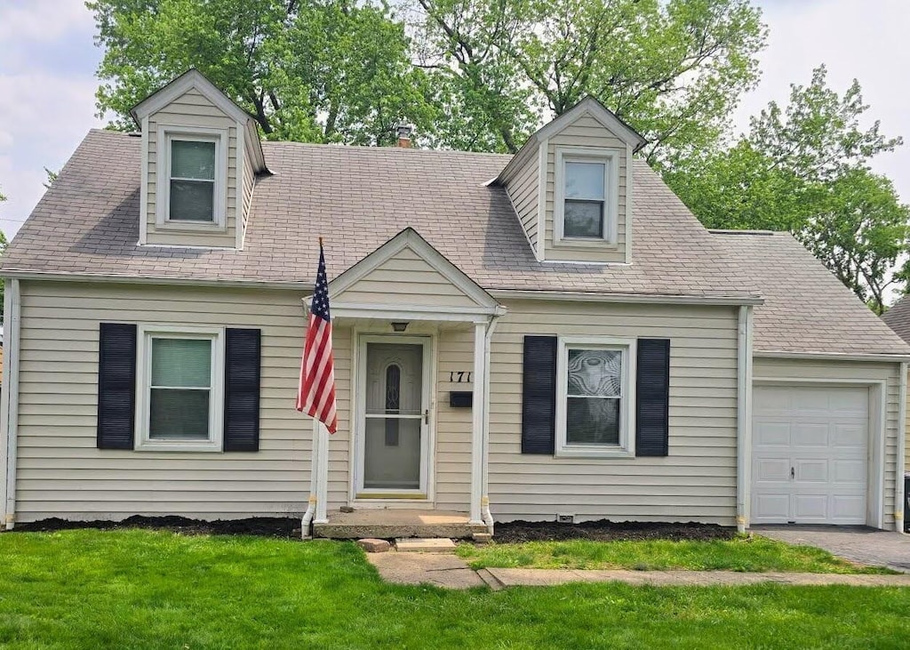 1710 Hess Blvd, Columbus, OH 43212 - new england style home featuring a garage, a front lawn, and asphalt driveway